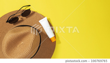 Things for beach sunscreens, hat and sunglasses. Safe exposure to sun. Skin Cancer Awareness Month Concept. Top view. Copy space 100769765