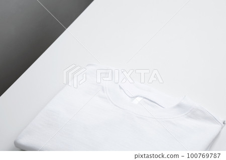 Basic folded white t-shirt. Mock up for branding t-shirt. Copy space Basic folded white t-shirt. Mock up for branding t-shirt. Copy space 100769787