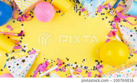 Birthday party attributes. Colorful balls, confetti, gifts, candles for cake. Yellow background. Top view. Copy space Birthday party attributes. Colorful balls, confetti, gifts, candles for cake. Yellow background. Top view. Copy space 100769816