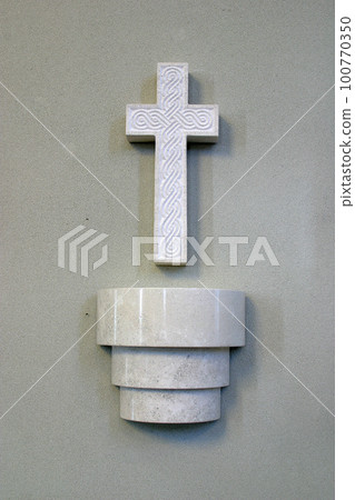 Holy water font and cross in the church of St. Quirinus of Sescia in Sisak, Croatia Holy water font and cross in the church of St. Quirinus of Sescia in Sisak, Croatia 100770350
