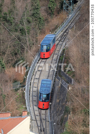 Modern funicular climbing to Schlossberg in Graz, Austria 100770438