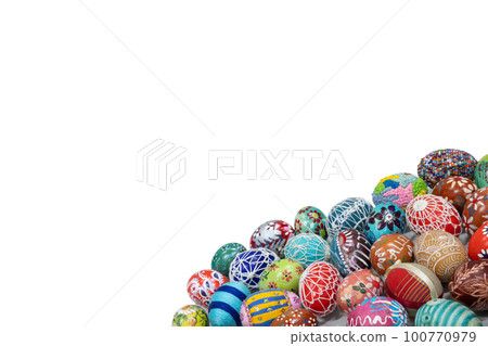 A collection of colorful Easter eggs arranged close together in the lower corner of the frame. 100770979
