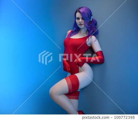 sexy girl in red bodysuit stockings and red gloves poses erotically against the background sexy girl in red bodysuit stockings and red gloves poses erotically against the background 100772398