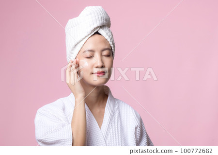 Beautiful young asian woman happy with clean face skin in towel and bathrobe, spa suit on pink background. Skincare, treatment, wellness therapy, facial care, beauty female health, cosmetology concept Beautiful young asian woman happy with clean face skin in towel and bathrobe, spa suit on pink background. Skincare, treatment, wellness therapy, facial care, beauty female health, cosmetology concept 100772682