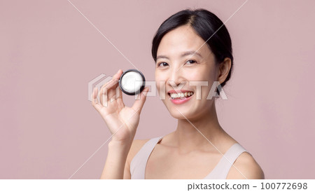 Young asian woman with facial skincare face cream, cosmetic moisturiser on healthy natural skin make up face. Portrait glowing smile girl person model with care beauty product, spa, cosmetology. Young asian woman with facial skincare face cream, cosmetic moisturiser on healthy natural skin make up face. Portrait glowing smile girl person model with care beauty product, spa, cosmetology. 100772698