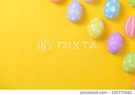 Happy easter holiday celebration concept. Group of painted colourful eggs decoration on a yellow background. Seasonal religion tradition design. Top view, flat lay, copy space. Happy easter holiday celebration concept. Group of painted colourful eggs decoration on a yellow background. Seasonal religion tradition design. Top view, flat lay, copy space. 100773092