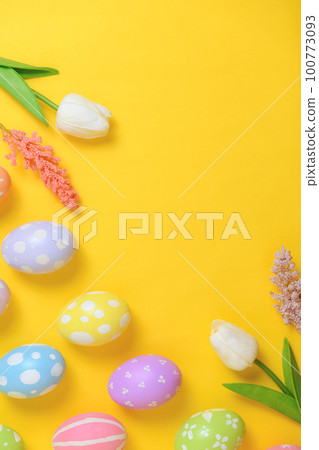 Happy Easter holiday greeting card design concept. Colorful Easter Eggs and spring flowers on yellow background. Flat lay, top view, copy space. Happy Easter holiday greeting card design concept. Colorful Easter Eggs and spring flowers on yellow background. Flat lay, top view, copy space. 100773093