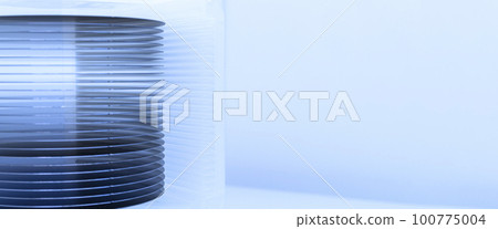 A lot of silicon wafers packed in a plastic storage box in the clean room of a semiconductor foundry ready for microchip production.Banner. 100775004