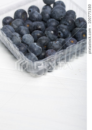Large blueberries in a decorative container. International day without diets. On a white background. Close-up. 100775380