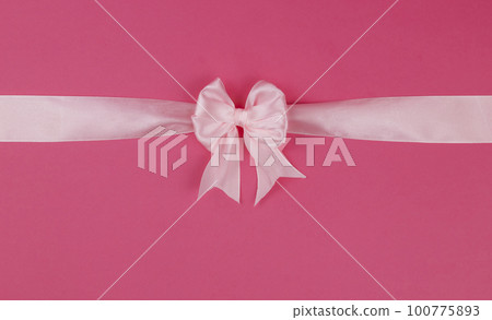 Pink bow with ribbon isolated on pink background. View from above. Gift decoration concept. 100775893