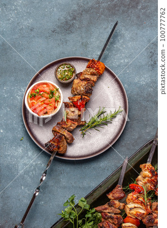 Bbq grilled meat pork and vegetable skewers on gray plate . Top view, flat lay, gray background Bbq grilled meat pork and vegetable skewers on gray plate . Top view, flat lay, gray background 100777762