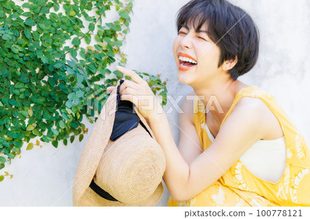 young woman wearing a yellow dress 100778121