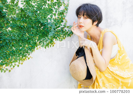 young woman wearing a yellow dress young woman wearing a yellow dress 100778203