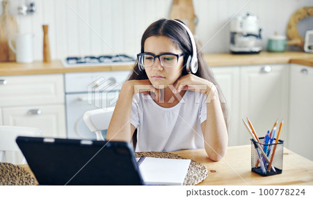 Girl e-learning, use tech, experiences vision problems Girl e-learning, use tech, experiences vision problems 100778224