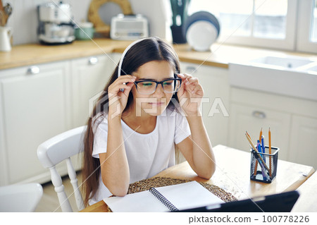 Girl e-learning, use tech, experiences vision problems Girl e-learning, use tech, experiences vision problems 100778226