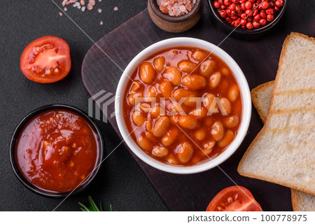 Delicious canned beans in a tomato in a white ceramic bowl Delicious canned beans in a tomato in a white ceramic bowl 100778975