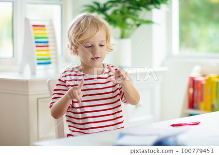 Child doing school homework. Online learning. Child doing school homework. Online learning. 100779451