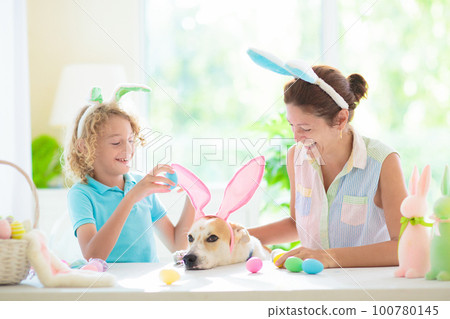 Mother and kid, family coloring Easter eggs. Mother and kid, family coloring Easter eggs. 100780145