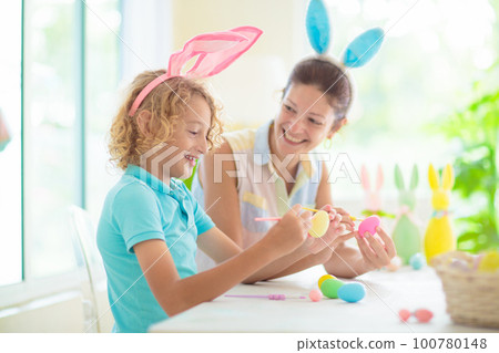 Mother and kids, family coloring Easter eggs. 100780148