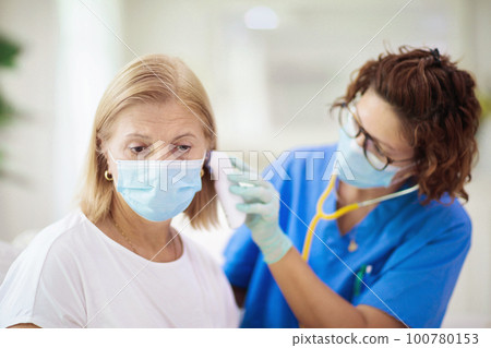 Doctor examining sick patient. Ill woman in clinic 100780153