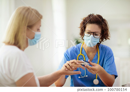 Doctor examining sick patient. Ill woman in clinic 100780154
