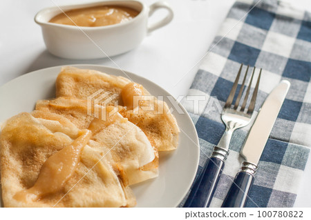 pancakes crepes with caramel sauce lay on a plate pancakes crepes with caramel sauce lay on a plate 100780822