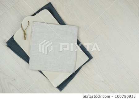 Ceramic kitchen board with a textile beige towel on wood background. Copy space.Top view.. 100780933