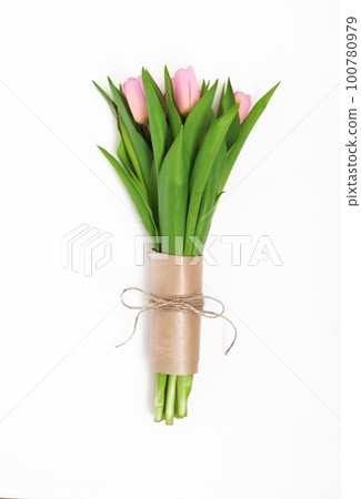 Bouquet of light pink tulips packed in kraft paper in retro style isolated on white background Bouquet of light pink tulips packed in kraft paper in retro style isolated on white background 100780979