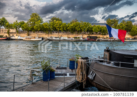 River Seine With House Boats And Promenade And French Flag In Paris, France 100781139