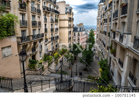Narrow Alley With Ancient Buildings And Stairs At Montmartre Hill In Paris, France Narrow Alley With Ancient Buildings And Stairs At Montmartre Hill In Paris, France 100781145
