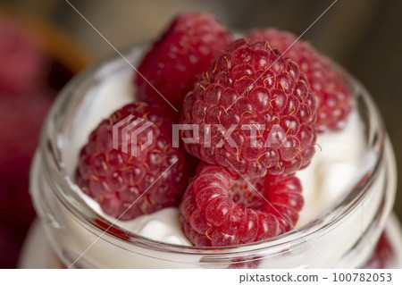 Fresh milk yogurt with whole fresh raspberries Fresh milk yogurt with whole fresh raspberries 100782053