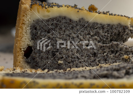 a cut piece of cake with poppy seed filling 100782109