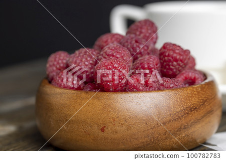 Harvested red ripe raspberries in the kitchen Harvested red ripe raspberries in the kitchen 100782783