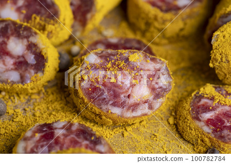 Pork meat sprinkled and dried in ground yellow turmeric Pork meat sprinkled and dried in ground yellow turmeric 100782784
