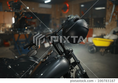 Motorbike parked in biker garage or service motor shop Motorbike parked in biker garage or service motor shop 100783187