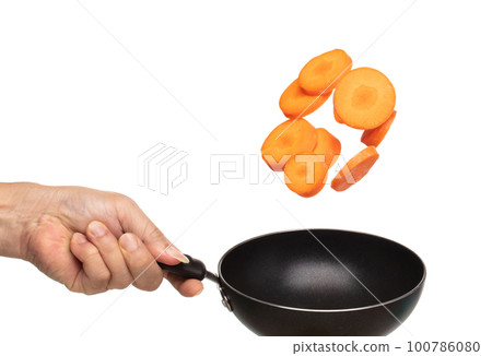 Carrot fresh fly float in Air turn to slice shape. Beta Carotene orange color in Carrot is good health. Many Dice cube carrot flying throw up in Air by cooking pan. White background isolated 100786080