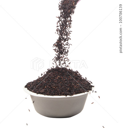 Riceberry rice pouring down in to bowl cup, black purple berry grain wave floating, fall in air. Rice Berry is organic healthy food. White background Isolated high speed shutter, freeze stop motion 100786139