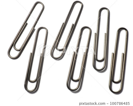 Metal paper clips on a white background. office supplies. isolated Metal paper clips on a white background. office supplies. isolated 100786485