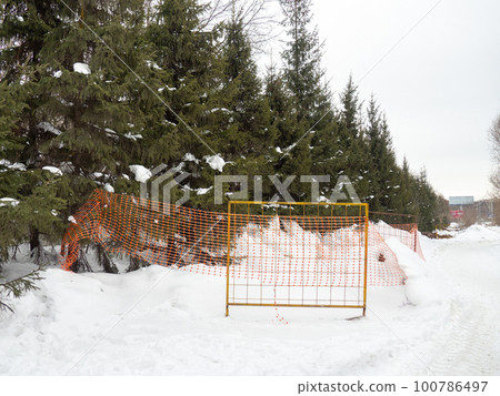 Winter day. Trees under the snow. Nature in the city. Urban environment. After a snowfall. Fences 100786497