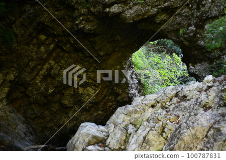 Moss-covered rocks of Kuguri Falls in summer daytime Moss-covered rocks of Kuguri Falls in summer daytime 100787831