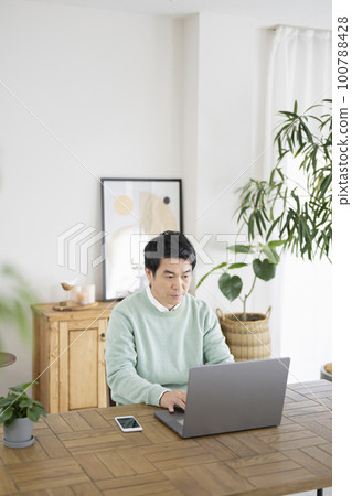 A man in his 50s working from home A man in his 50s working from home 100788428