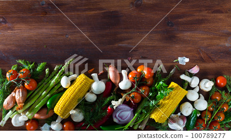 Mushrooms, vegetables, greens on wooden background Mushrooms, vegetables, greens on wooden background 100789277