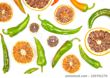 hot green peppers and dried citrus fruit on a white background. grocery organic flatley 100792270