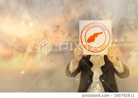 Businesswoman holding a board with stop terrorism sign Businesswoman holding a board with stop terrorism sign 100792611