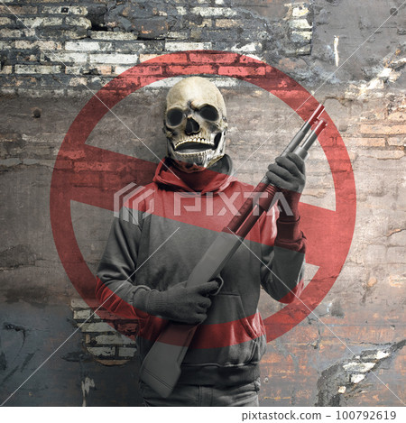 A man wearing a mask holding a gun with stop terrorism sign A man wearing a mask holding a gun with stop terrorism sign 100792619