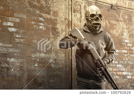 Man wearing a mask holding a gun Man wearing a mask holding a gun 100792626
