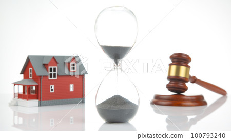 court and auction gavel on the background of a house model. sale and purchase of real estate. court and auction gavel on the background of a house model. sale and purchase of real estate. 100793240