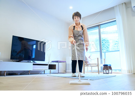 A woman cleaning the floor 100796035