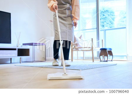 A woman cleaning the floor A woman cleaning the floor 100796040