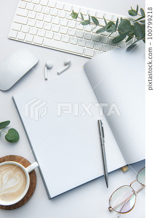 Modern white office desk table with laptop, notebook and other supplies. Modern white office desk table with laptop, notebook and other supplies. 100799218